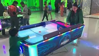 Tawaf playing air hockey with mumma