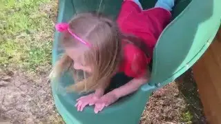 CUTE LITTLE GIRL GOES DOWN TUBE SLIDE FACE FIRST