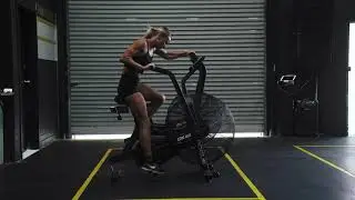 Strong Woman Riding Exercise Bike