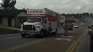 instant Karma!! jaywalking Lady walks into Uhaul truck while flipping off cars.