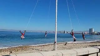 Traditional Mexican Papantla Flyers Dance, men on poles hanging upside down, Puerto Vallarta, clip 2