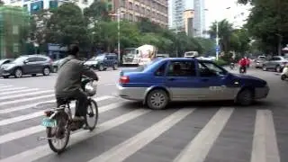 Scootering Through Downtown Nanning.  China.