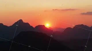 Stunning orange sky at sunset above limestone peaks of Laos from tripod aerial perspective