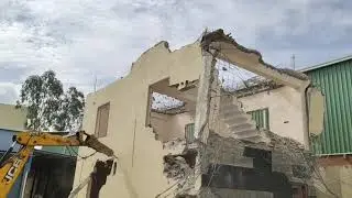 Building demolition by jcb breaker