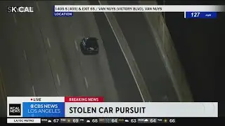 Stolen car speeds past traffic, crashes into divider during pursuit