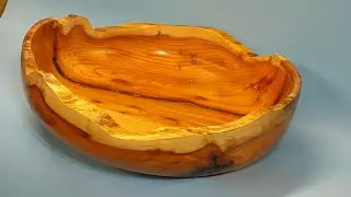 A Yew bowl with a bark inclusion filled with resin and a natural edge #83 wood turning