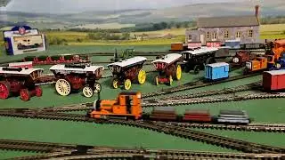 Bachmann Rheneas pulling 1 brown, 1 red, 1 grey slate wagons 