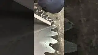The worker used a deburring tool to smooth the edges of the metal part.