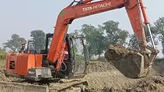 Excavation of soil with jcb Hitachi machine and embankment of the canal is in progress
