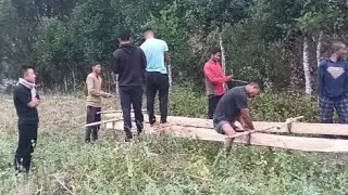 Carrying Wood to build house with friends 