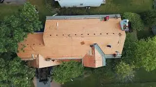 Drone View of Roofers Re-Roofing a Roof in Wilmington, NC