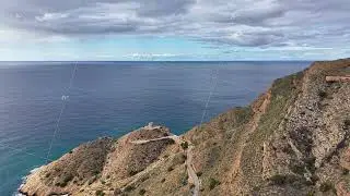 Elevated route along rugged coastline featuring lush vegetation and breathtaking sea views from