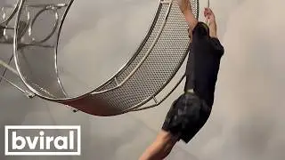 Acrobat Performs Daring Stunts on Spinning Wheel of Death