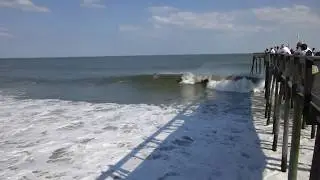 Surfers Riding Some Big Waves In Ocean City Maryland By The Pier