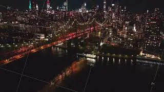 Aerial views capture Queensboro Bridge and Roosevelt Island alongside breathtaking Manhattan skyline