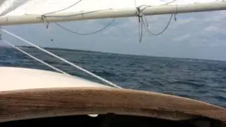 Herreshoff America Catboat surfing on a following sea.
