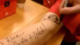 Wade Rouse & Gary Edwards sign an arm.