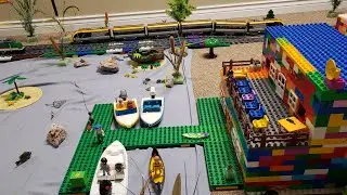 Lego train track setup around a lake