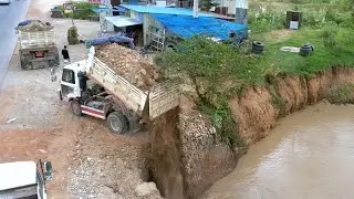 Engineering a Riverbank: Dump Truck Delivers Soil to Prevent Erosion and Reclaim Land