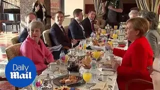 Theresa May meets Angela Merkel at the EU-Arab League summit