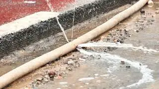 Water pipe leaking, gushing water from damaged pipeline at construction site