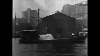 Film shows the East River shoreline and the piers of lower Manhattan 1903