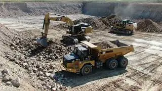 Giant Excavators Loading Dump Trucks - Heavy Machinery in Action