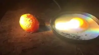 Sun cooked sunny side up egg--with magnifying glass from television
