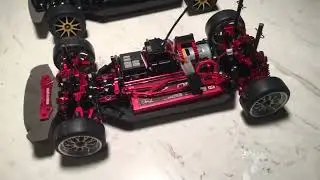 Rc Car | Yeah Racing Tamiya TT-02 (Red) Aluminum Upgrade Kit next to Stock rolling chassis
