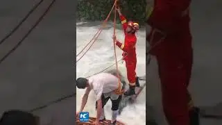 Driver trapped in flash flood, rescued by firefighters with two ladders