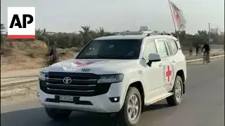 Red Cross convoy travels in Gaza, believed to be on way to pick up the first Israeli hostages