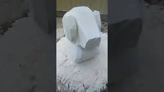 Ram bust carving out of limestone adding horn shaping