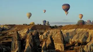 Desert Skies Aglow: Hot Air Balloons Over Majestic Hills 🌵🎈