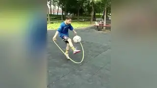 Chinese boy juggles a football while skipping