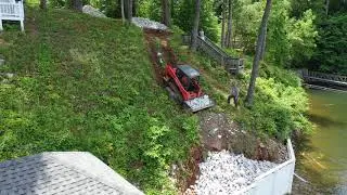Kubota Hauling Rip Rap on steep lakeside hill, video 1 of 3