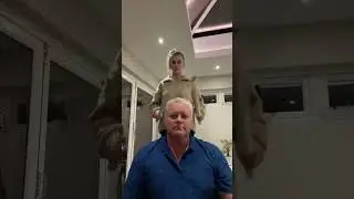 Dad and daughter using wrapping paper tubes to play music on dad's head!