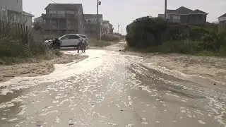 Hurricane Erin stirs up strong winds and floods part of NC highway as it slowly moves out to sea