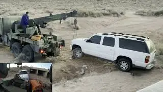 M936A2, a military Wrecker, pulling Suburban from a ditch