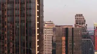 Modern architectural details of tall glass skyscrapers in Bangkok, Thailand. Camera descends