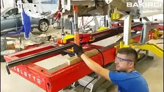 Celette Naja 3D measuring system used during car frame straightening process on a Celette car bench
