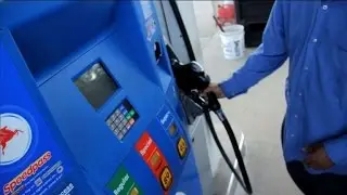 MoneyWatch: Gas prices hit four-year low; NFL sidelines go high tech