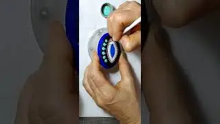 Painting another magical piece of art beauty/evil eye on a sea stone