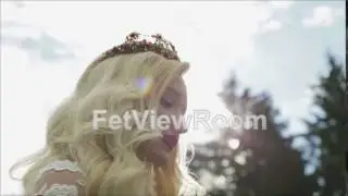 A young blond bride drinking tea. She is happy