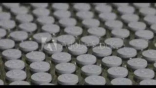 Stock video injection vial stopper cap in focus. vaccine vial bottle in pharma factory manufacturing