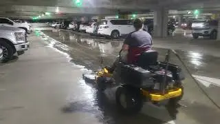 Using a custom riding surface cleaner to pressure wash parking garage . Dallas Texas