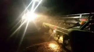 S670 John Deere with 35 foot draper head combining soy beans at night