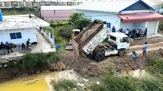 Earthwork activities to prepare roads flooded by rain, medium-sized machinery