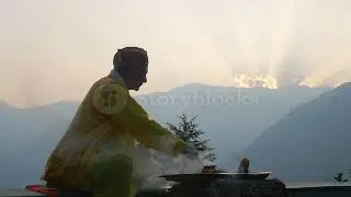 a hindu old man in yellow  costume offering special spiritual prayer