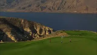 Kamloops - Tobiano Golf Course - Aerial shot of players on the course, water, hoodoos in background