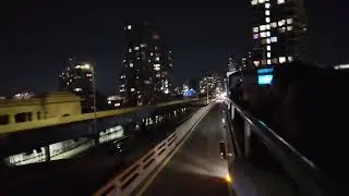 Open top bus drive through New York at night